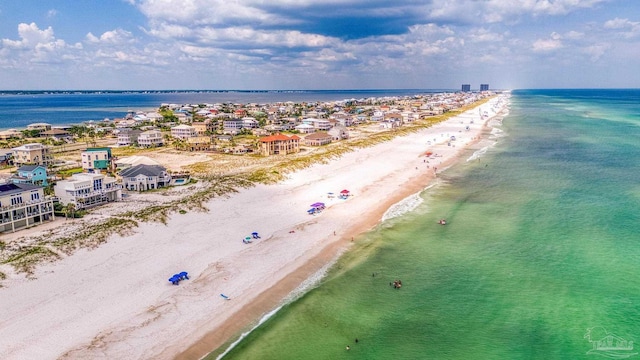 drone / aerial view featuring a beach view and a water view