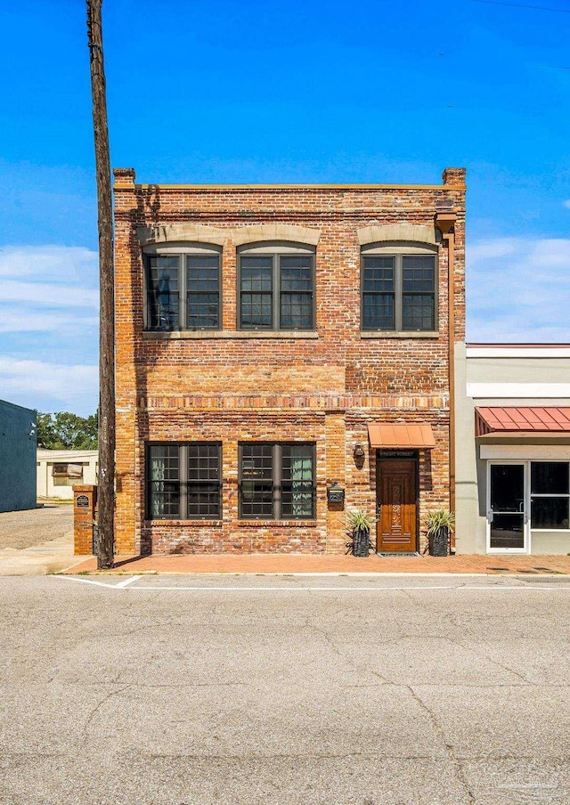 view of property featuring brick siding