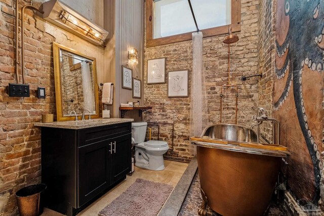 full bath featuring brick wall, a towering ceiling, and toilet