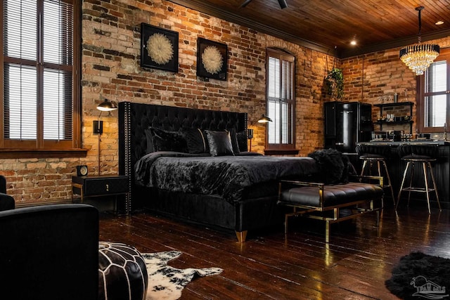 bedroom with wooden ceiling, brick wall, hardwood / wood-style floors, an inviting chandelier, and crown molding