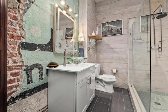 full bath featuring vanity, a shower stall, toilet, and wooden walls