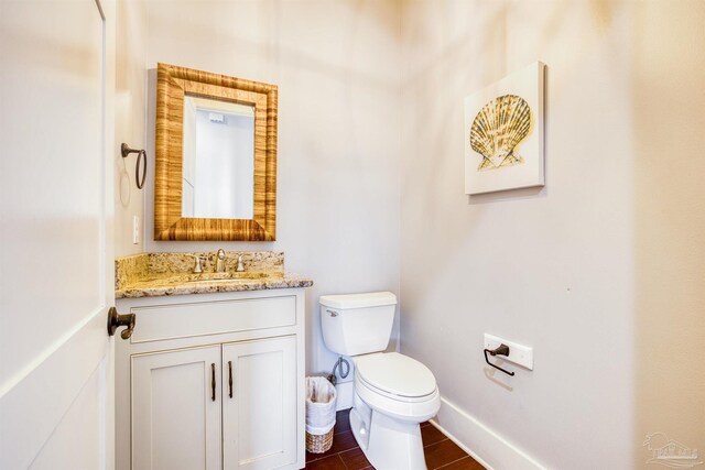 712 Maldonado Dr, Pensacola Beach, FL 32561 - bathroom with toilet, vanity, baseboards, and wood finished floors