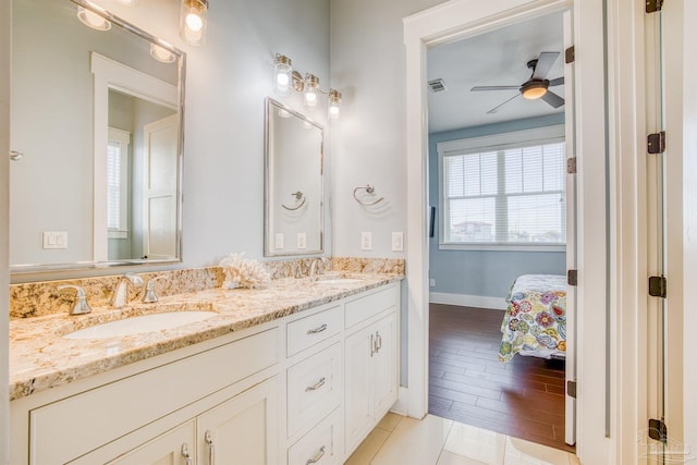 712 Maldonado Dr, Pensacola Beach, FL 32561 - ensuite bathroom featuring double vanity, connected bathroom, wood finished floors, and a sink