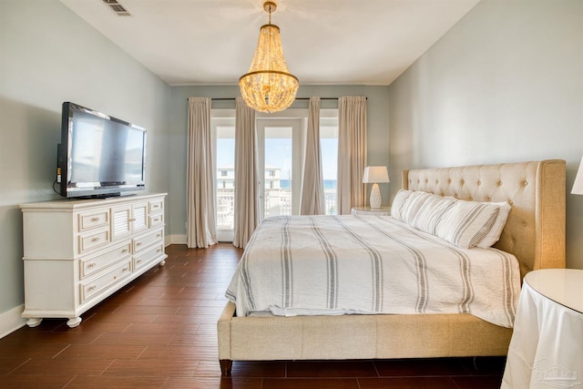 712 Maldonado Dr, Pensacola Beach, FL 32561 - bedroom featuring visible vents, baseboards, a notable chandelier, and dark wood-style floors