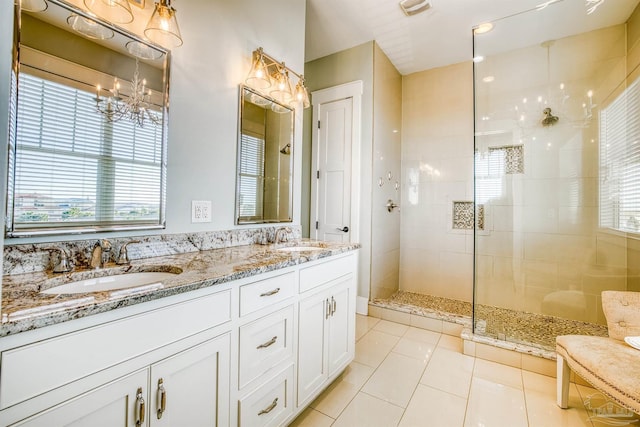 712 Maldonado Dr, Pensacola Beach, FL 32561 - full bathroom with tile patterned flooring, a notable chandelier, tiled shower, and a sink