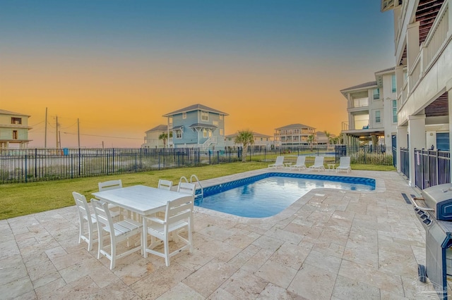712 Maldonado Dr, Pensacola Beach, FL 32561 - pool at dusk featuring a fenced in pool, fence, outdoor dining area, a yard, and a patio area