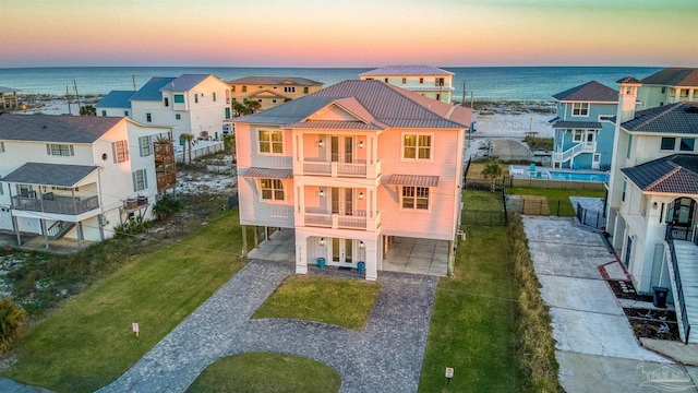 712 Maldonado Dr, Pensacola Beach, FL 32561 - exterior space featuring a residential view, concrete driveway, french doors, a balcony, and a carport