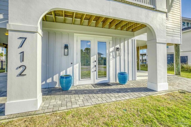 712 Maldonado Dr, Pensacola Beach, FL 32561 - view of exterior entry featuring board and batten siding and french doors