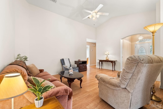 living room featuring light wood-type flooring, ceiling fan, and lofted ceiling