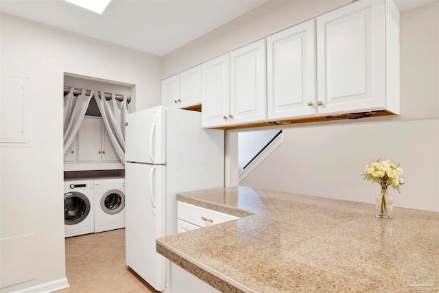 laundry room featuring washing machine and dryer and light tile patterned floors