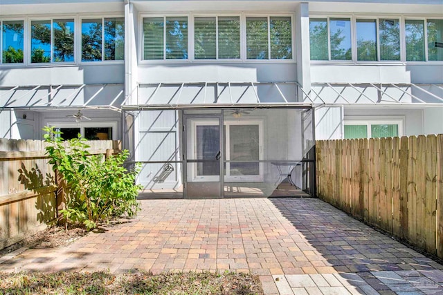 back of property with a patio area and ceiling fan