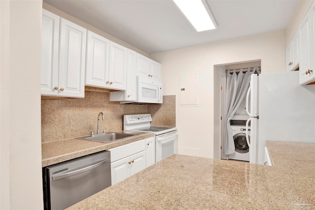 kitchen with white appliances, washer / clothes dryer, white cabinetry, and sink