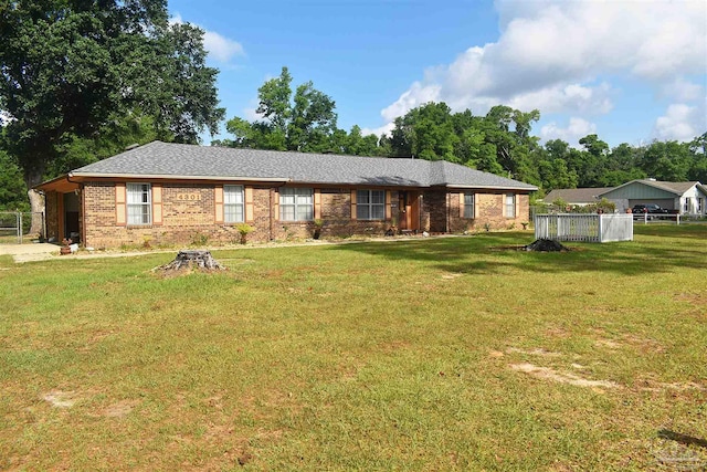 ranch-style home with brick siding, a front lawn, and fence