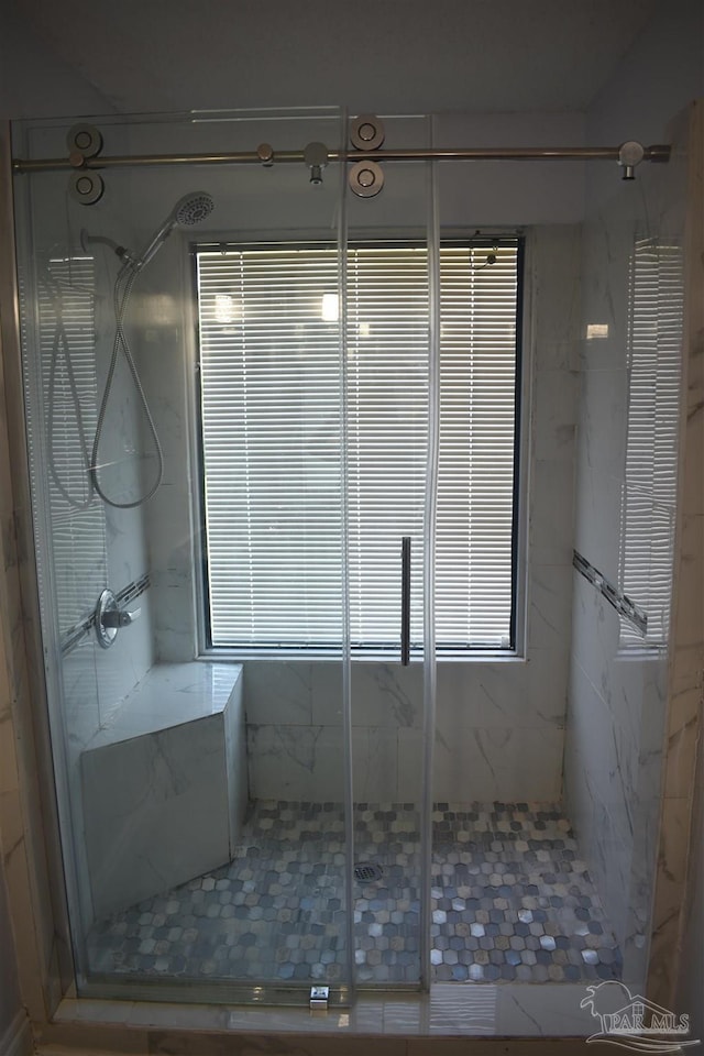 bathroom with a marble finish shower