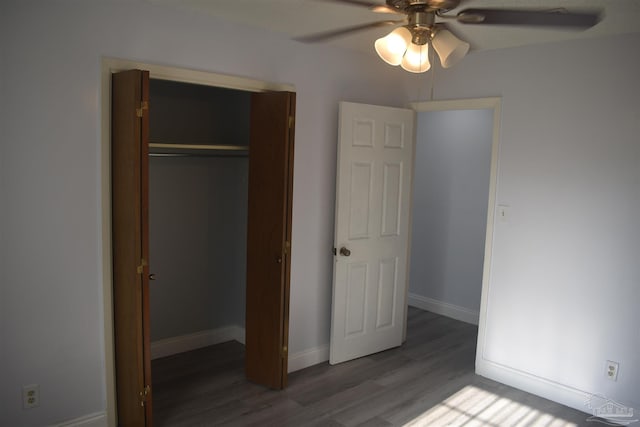 unfurnished bedroom with baseboards, a ceiling fan, wood finished floors, and a closet