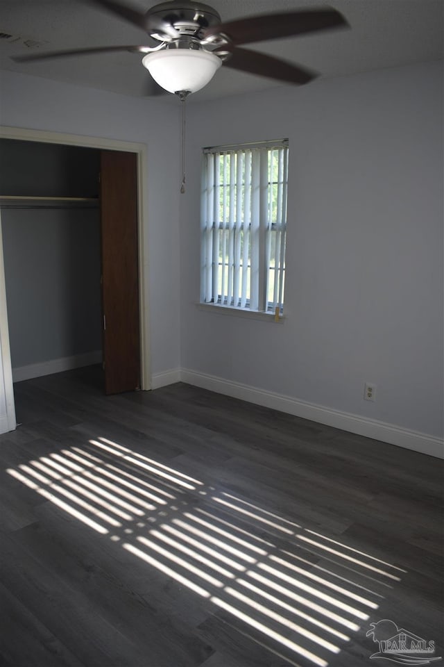 unfurnished bedroom with baseboards, ceiling fan, and wood finished floors