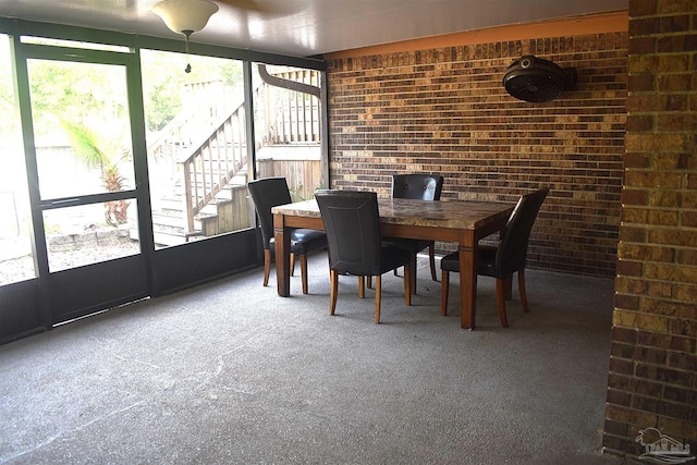 sunroom / solarium featuring outdoor dining space