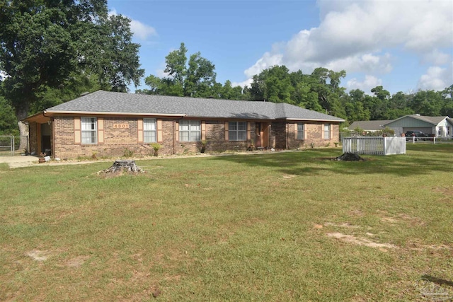 ranch-style house featuring fence, a front yard, and brick siding