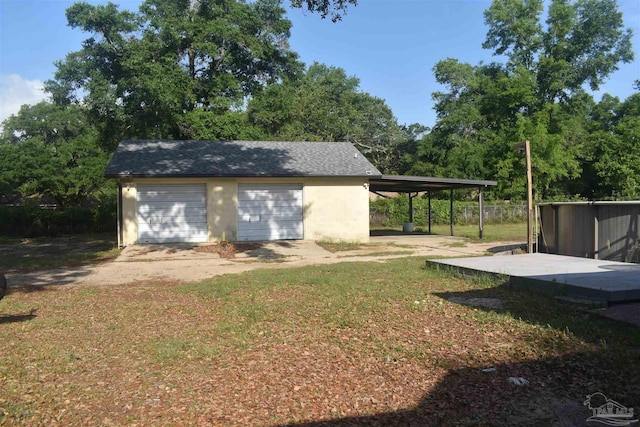 garage featuring a detached garage and driveway