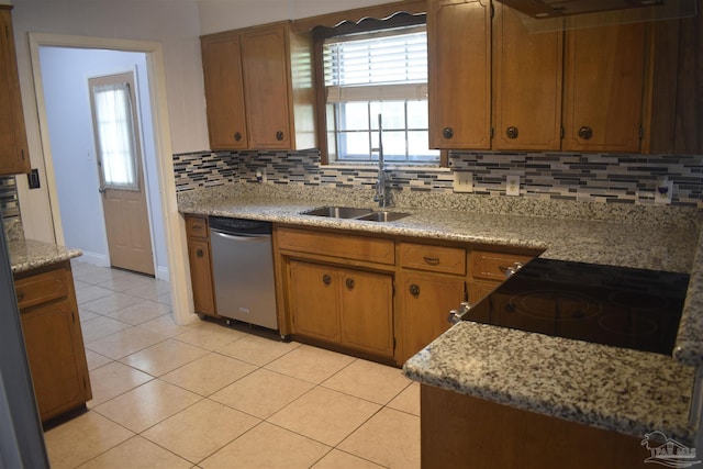 kitchen featuring stainless steel dishwasher, decorative backsplash, electric range oven, a sink, and light tile patterned floors