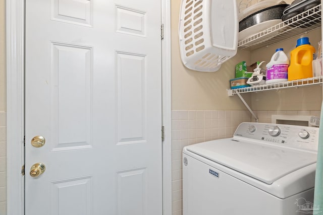 washroom with tile walls and washer / clothes dryer