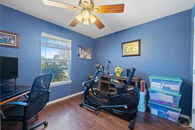 office area with ceiling fan, dark wood-type flooring, and a textured ceiling