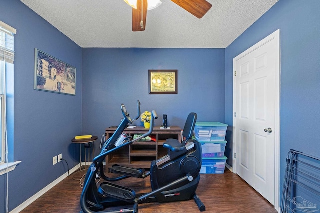 interior space featuring a textured ceiling, dark wood-type flooring, and ceiling fan