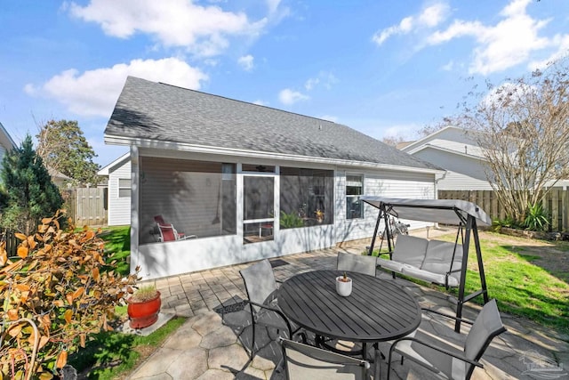 rear view of property featuring a patio and a sunroom