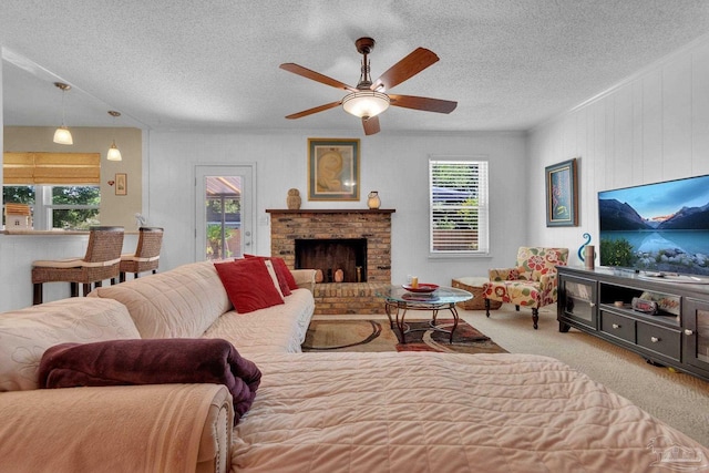 living room with a fireplace, light colored carpet, a textured ceiling, and ceiling fan