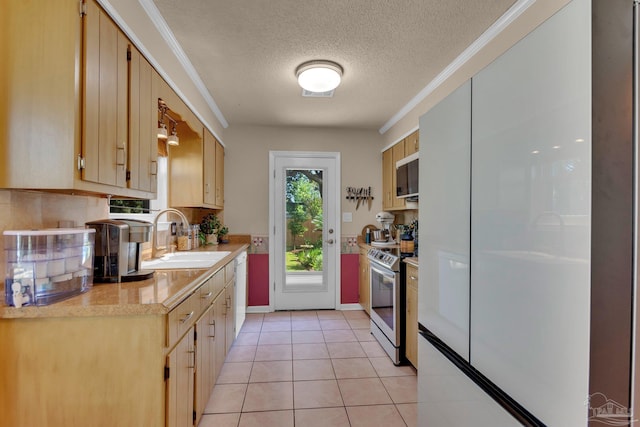 kitchen with stainless steel appliances, a textured ceiling, sink, light tile patterned flooring, and crown molding