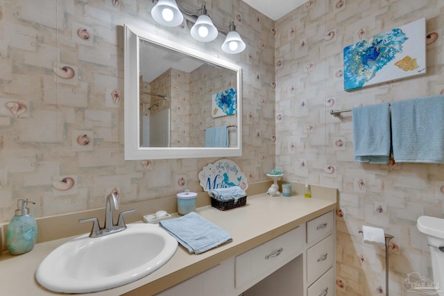 bathroom with curtained shower, vanity, and toilet