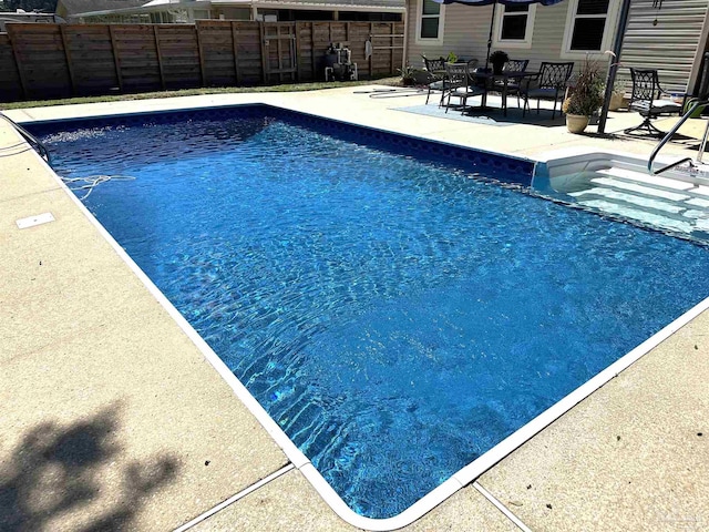 view of swimming pool with a patio