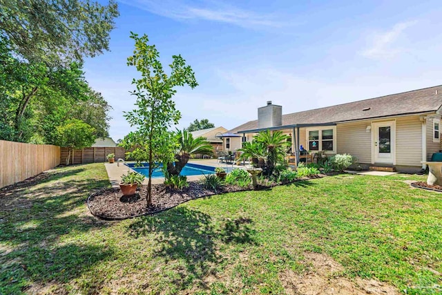 view of yard with a fenced in pool and a patio area