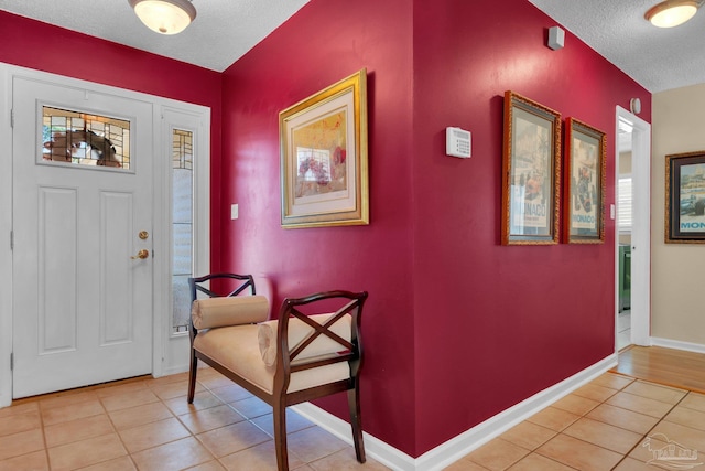 tiled entrance foyer with a textured ceiling