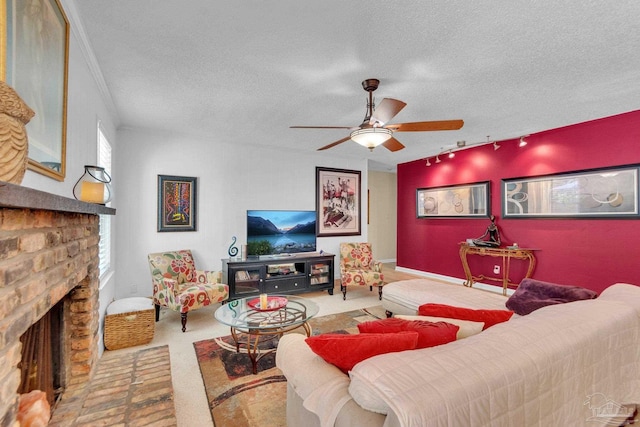 living room featuring a fireplace, plenty of natural light, a textured ceiling, and ceiling fan