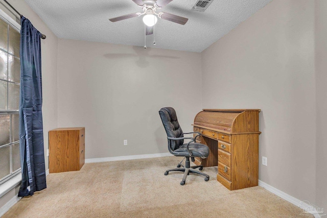 office area with light carpet, ceiling fan, and a textured ceiling