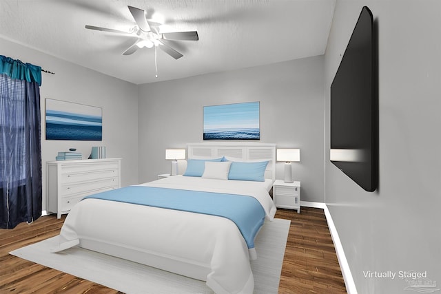 bedroom featuring ceiling fan and dark hardwood / wood-style floors