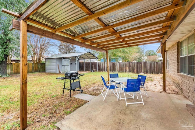 view of patio featuring area for grilling and a storage unit