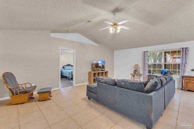 tiled living room with a textured ceiling, ceiling fan, and lofted ceiling