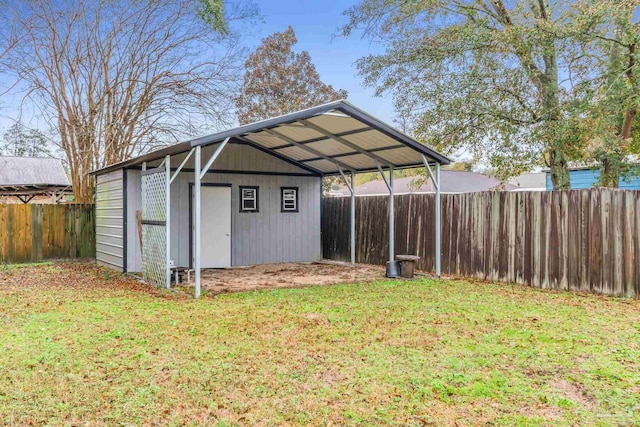 view of outbuilding with a carport and a yard