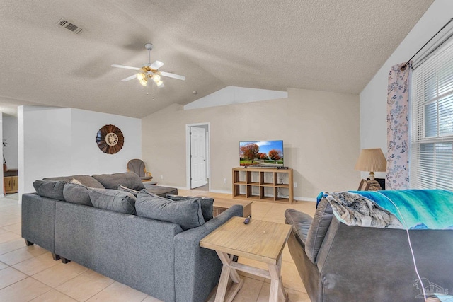 living room featuring a textured ceiling, ceiling fan, vaulted ceiling, and tile patterned floors