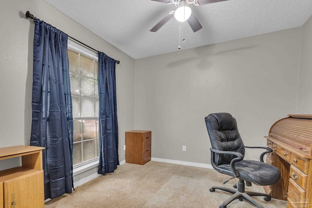 office area with ceiling fan, plenty of natural light, a textured ceiling, and carpet floors