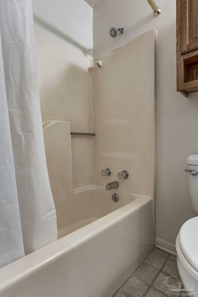 bathroom with toilet, tile patterned floors, and shower / tub combo