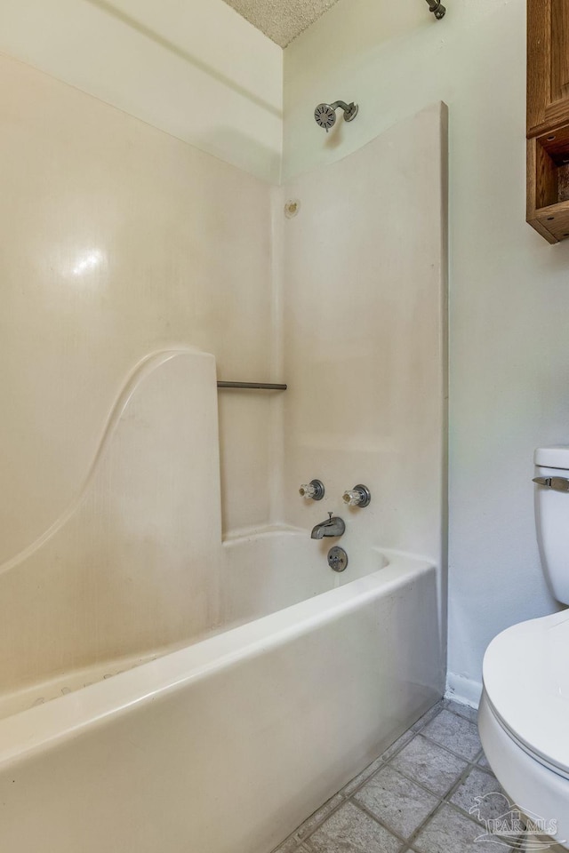 bathroom featuring tile patterned flooring, a textured ceiling, toilet, and shower / bathtub combination