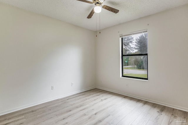 empty room with light hardwood / wood-style floors, ceiling fan, and a textured ceiling