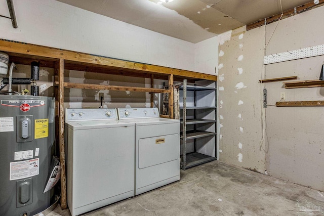 basement featuring electric water heater and washing machine and clothes dryer