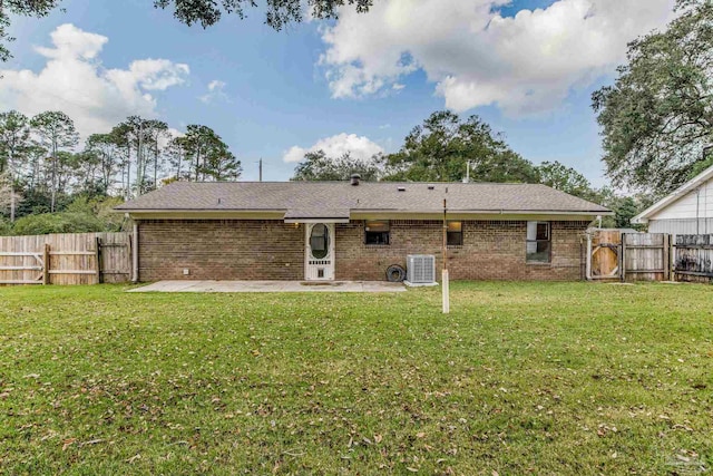 back of property with a yard, central AC, and a patio