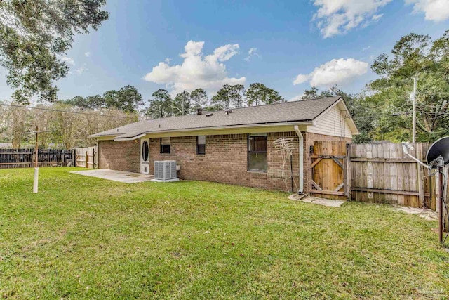 back of property featuring central air condition unit, a patio, and a yard