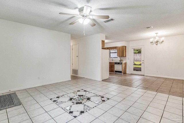 unfurnished living room featuring a textured ceiling, light tile patterned floors, and ceiling fan with notable chandelier