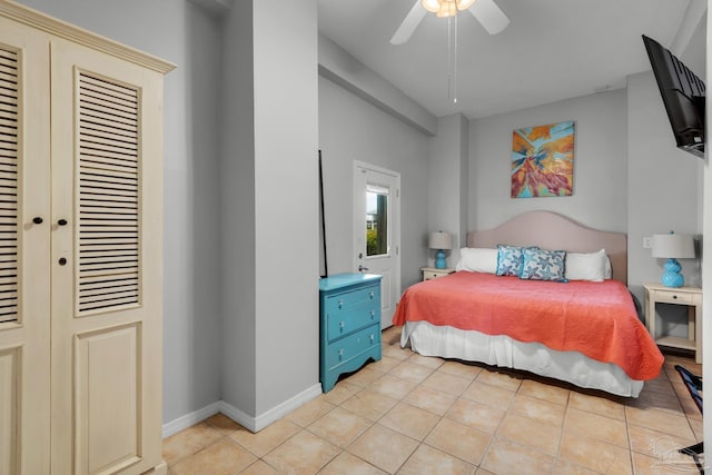 bedroom featuring light tile patterned flooring, ceiling fan, and a closet